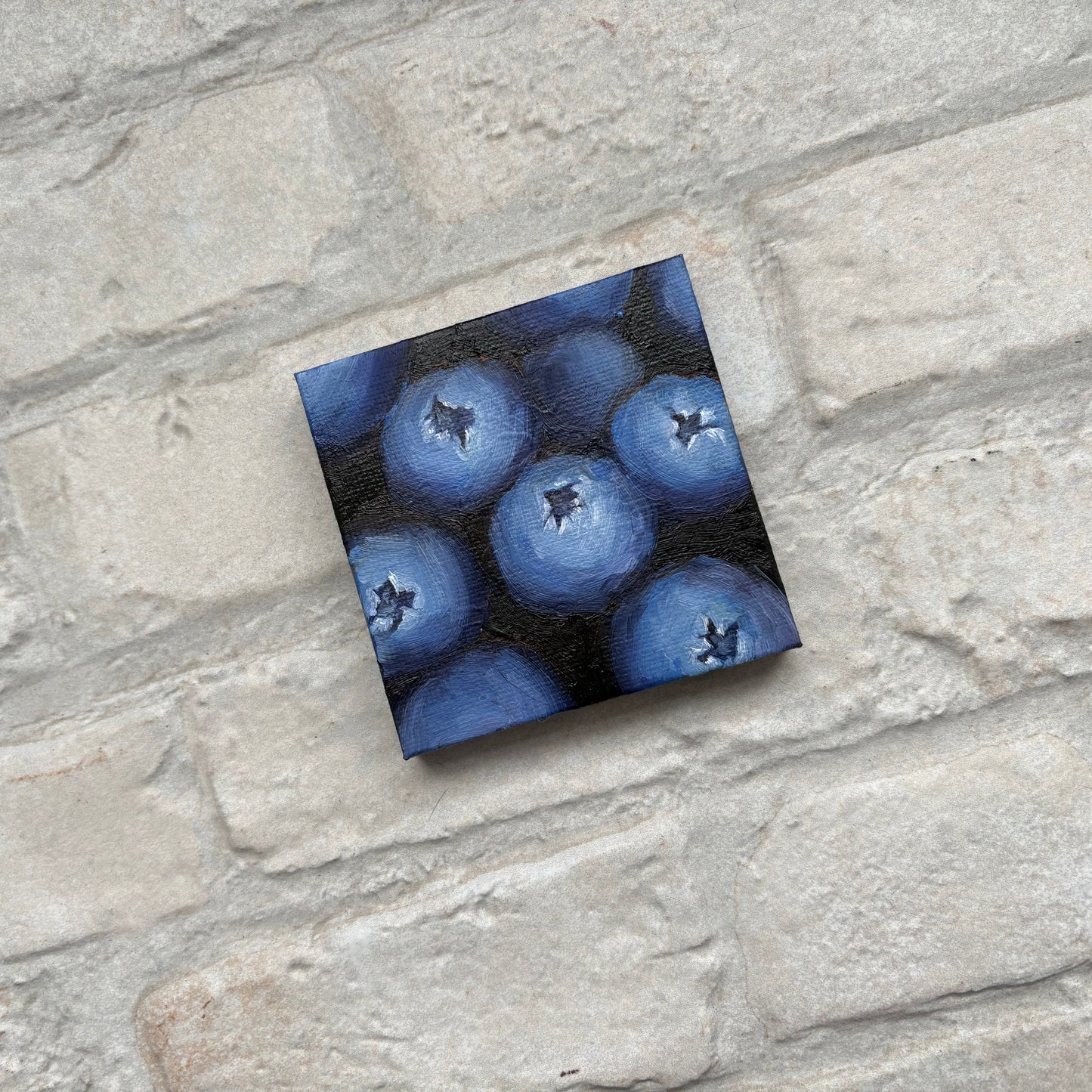 Square painting of blueberries on a mini canvas