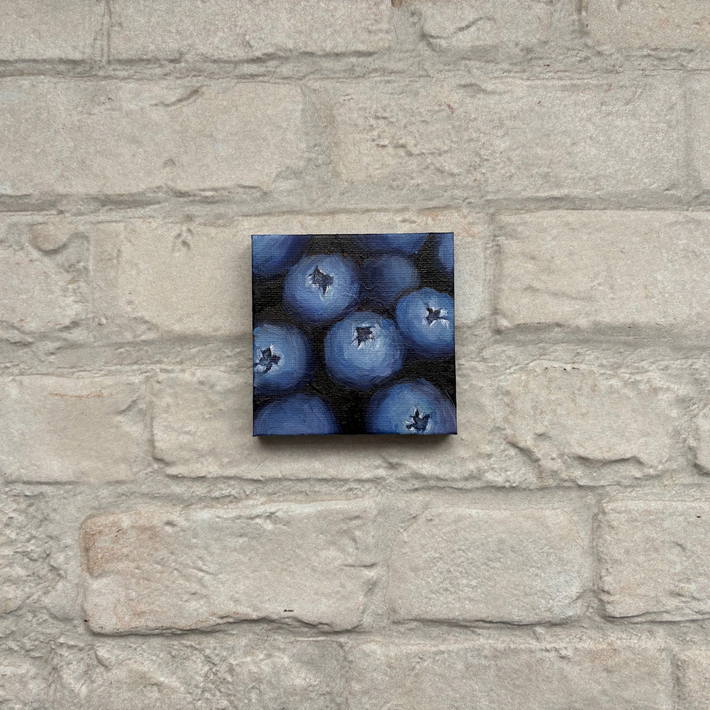 Square painting of blueberries on a mini canvas