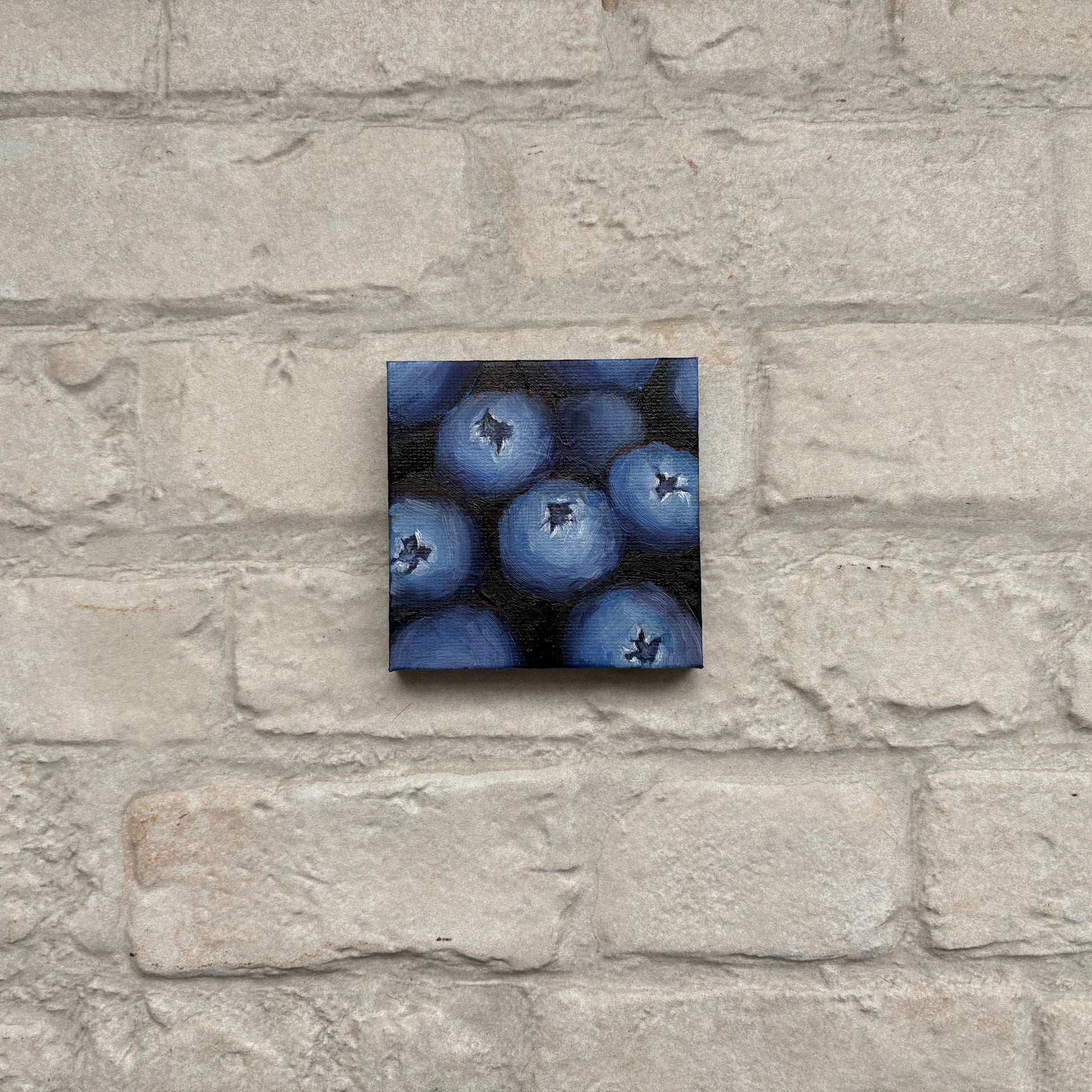 Square painting of blueberries on a mini canvas