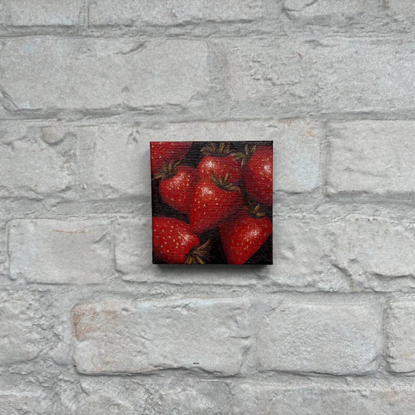 Square painting of strawberries on a mini canvas